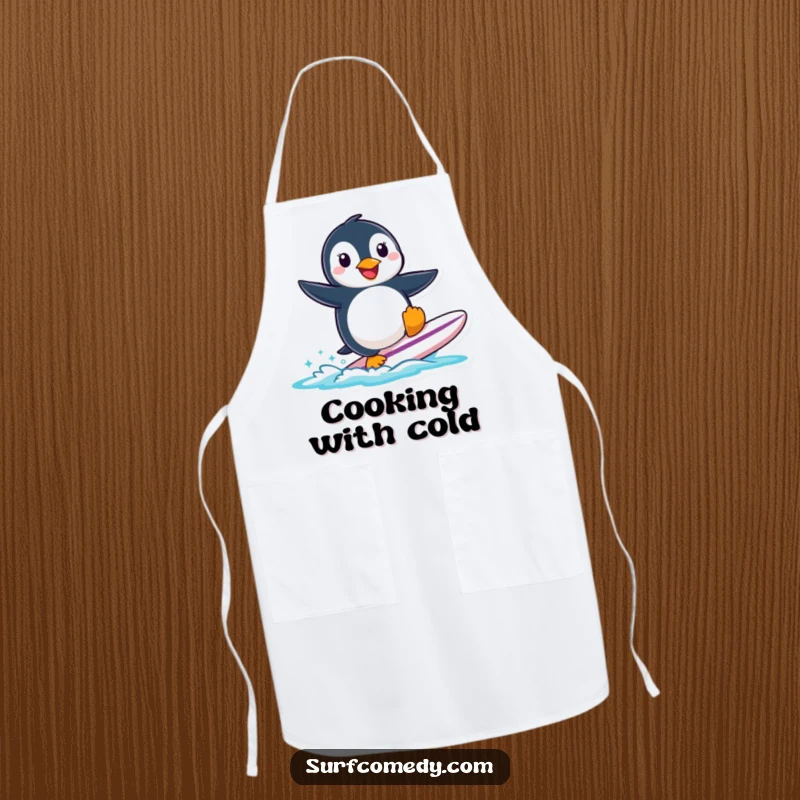 Funny smiling penguin character attempting to surf a small surfboard, depicted on a fun kitchen apron.