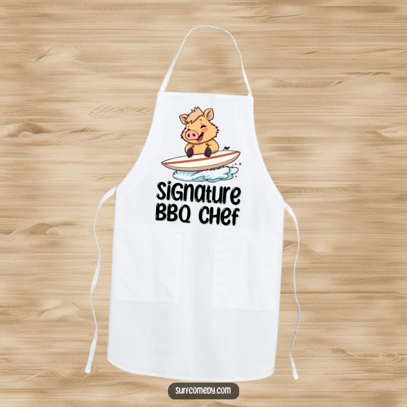 Funny apron with a happy boar signing autographs on a surfboard, ideal for culinary celebrations.