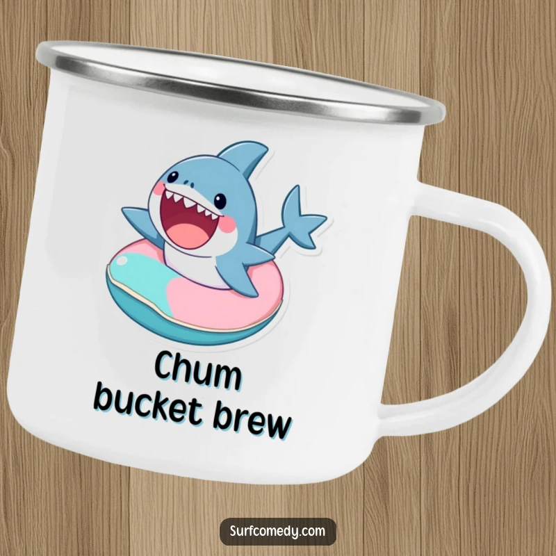 Funny enamel camping mug showing a cute shark excitedly riding a tiny, colorful inner tube, for outdoor adventures.