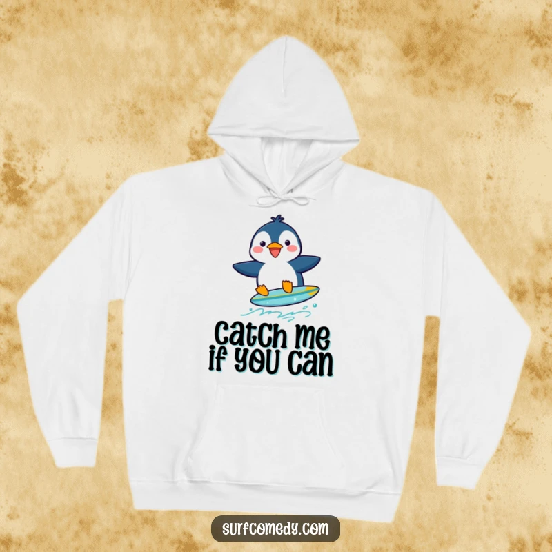 Funny penguin character wobbling precariously on a tiny surfboard, perfect for a cozy hoodie.