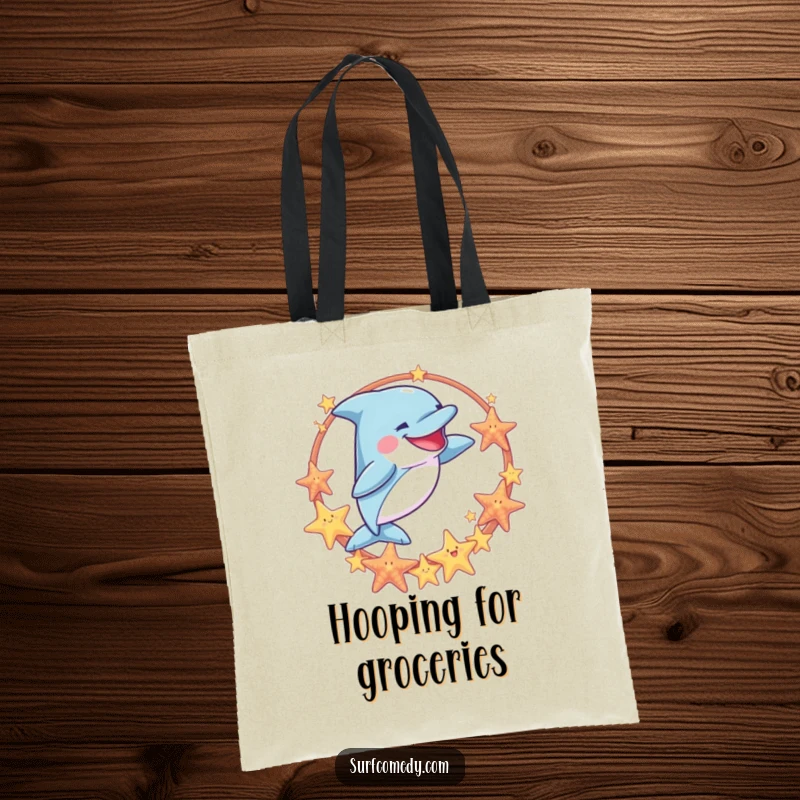 Funny tote bag showcasing a goofy dolphin jumping through a sea star hoop, perfect for carrying beach gear with a splash of humor.